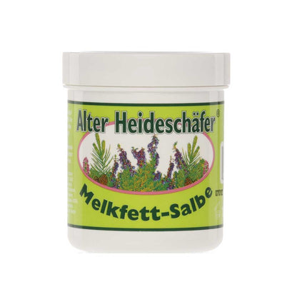 Melkfett-Salbe Alter Heideschäfer® im weißen Tiegel mit grünem Etikett und Pflanzenmotiv