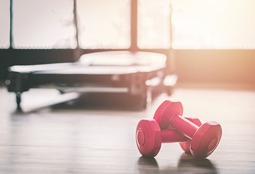 Pink dumbbells lying on the floor